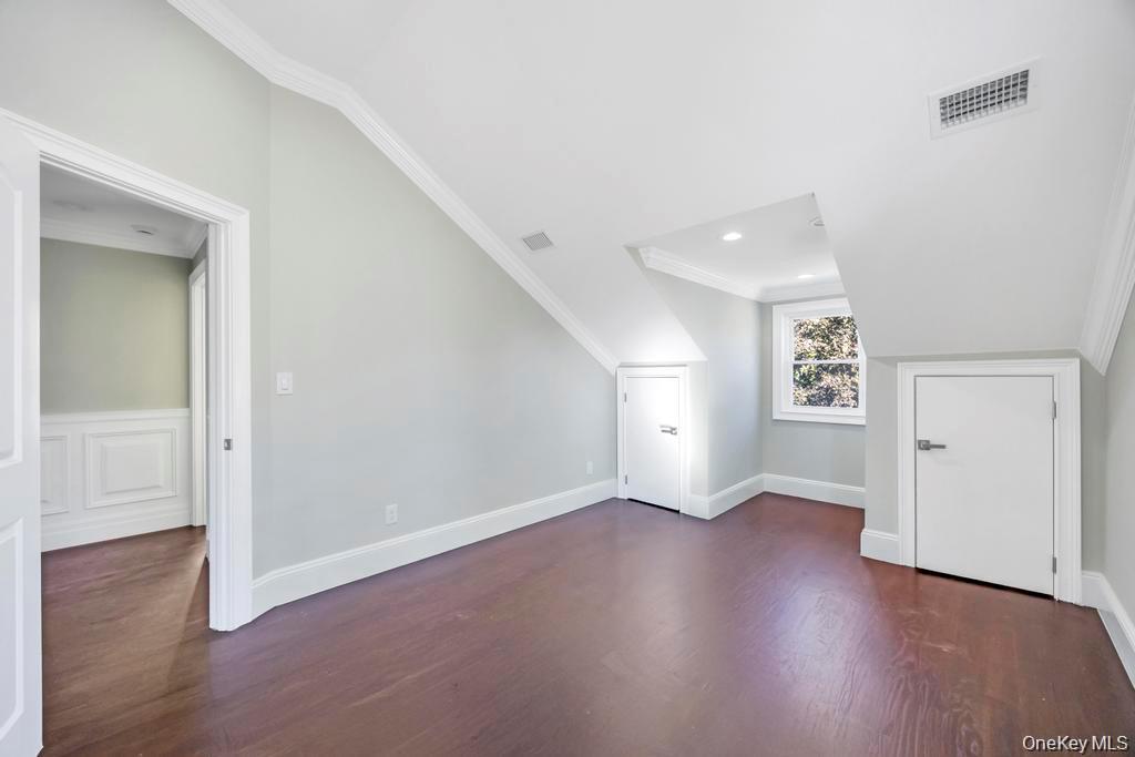 41 Perry Street Hempstead, NY 11550 - Photo 14 of 36 Bonus room featuring dark wood-style floors and baseboards