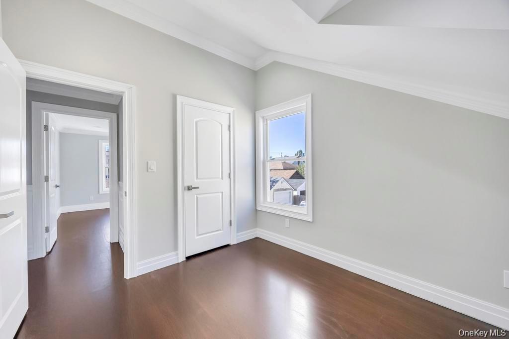 41 Perry Street Hempstead, NY 11550 - Photo 21 of 36 Unfurnished bedroom with dark wood-style flooring and crown molding