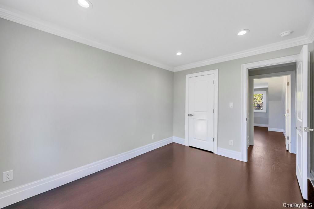 41 Perry Street Hempstead, NY 11550 - Photo 24 of 36 Unfurnished bedroom featuring recessed lighting, dark wood-style flooring, and crown molding