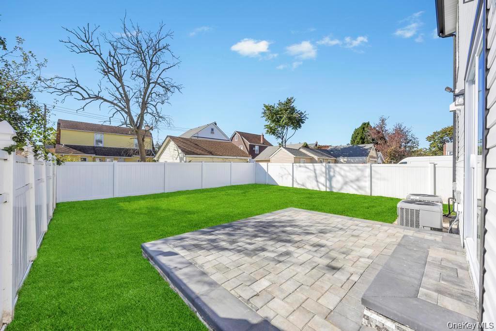 41 Perry Street Hempstead, NY 11550 - Photo 36 of 36 Fenced backyard featuring a patio area