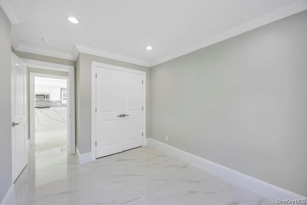41 Perry Street Hempstead, NY 11550 - Photo 10 of 36 Unfurnished bedroom with ornamental molding, a closet, light marble finish flooring, and recessed lighting