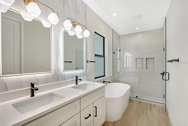 a bathroom with a double vanity sink mirror and toilet