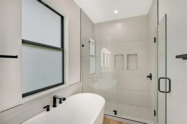 a bathroom with a shower sink and mirror