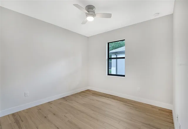 wooden floor in an empty room with a window