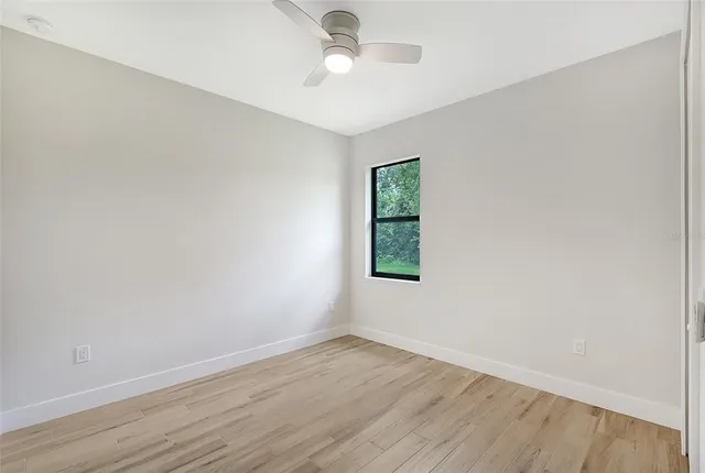 wooden floor in an empty room with a window