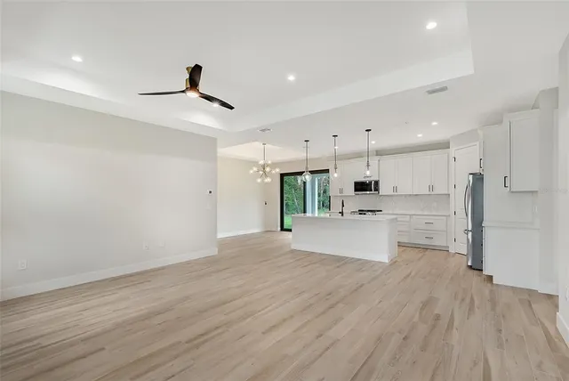 a view of kitchen with wooden floor and window