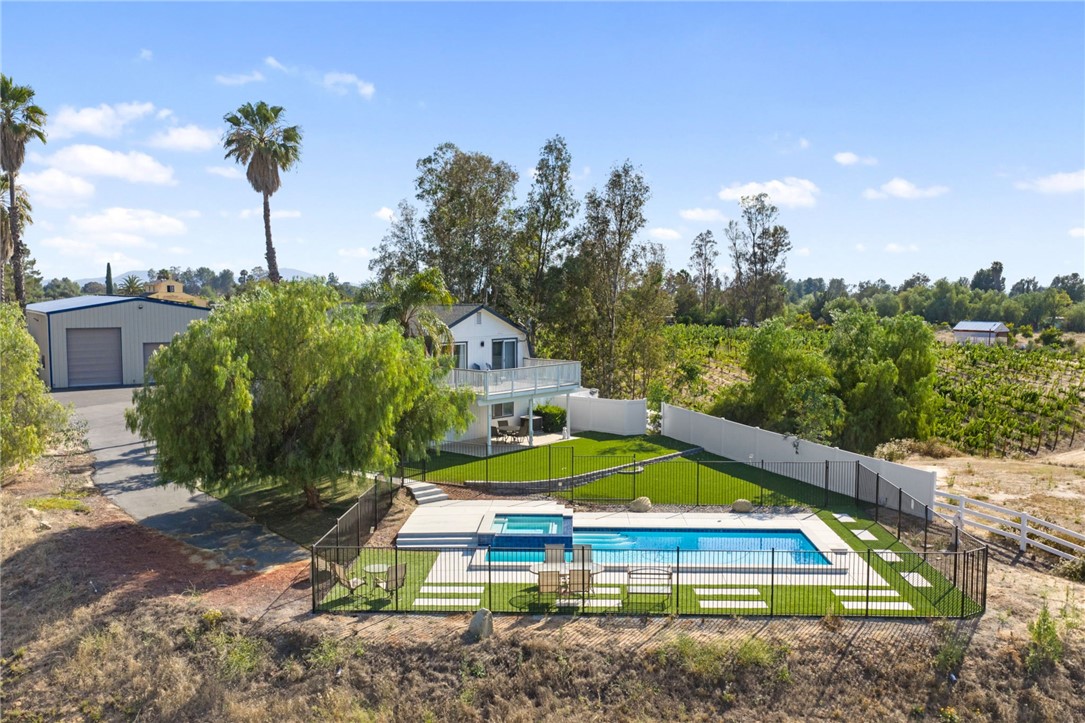 35825 Meadow Ridge Road Temecula, CA 92592 - Photo 15 of 75 a view of swimming pool with a yard and potted plants
