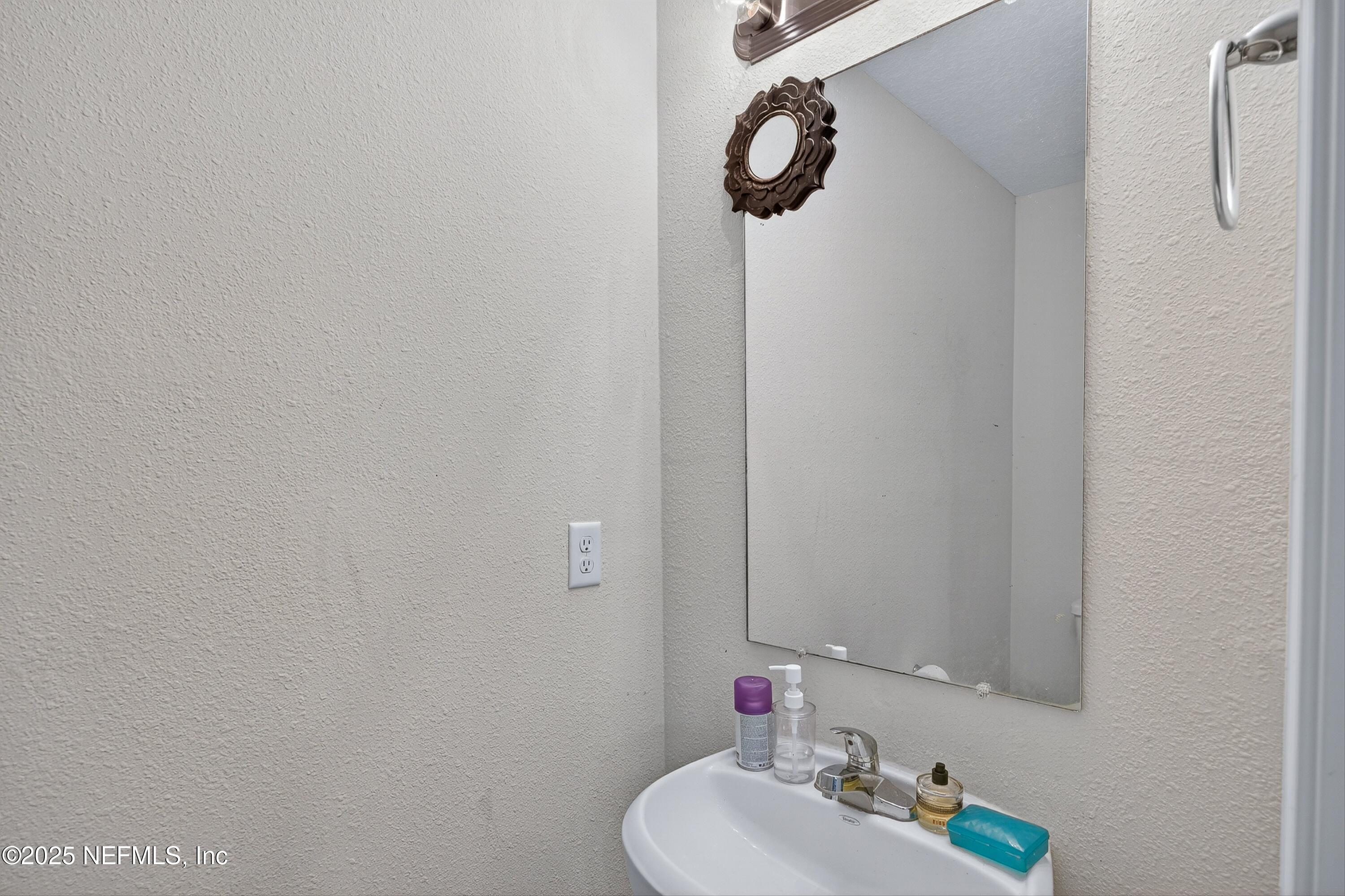 756 Talking Tree Drive Jacksonville, FL 32205 - Photo 12 of 26 a bathroom with a sink and mirror