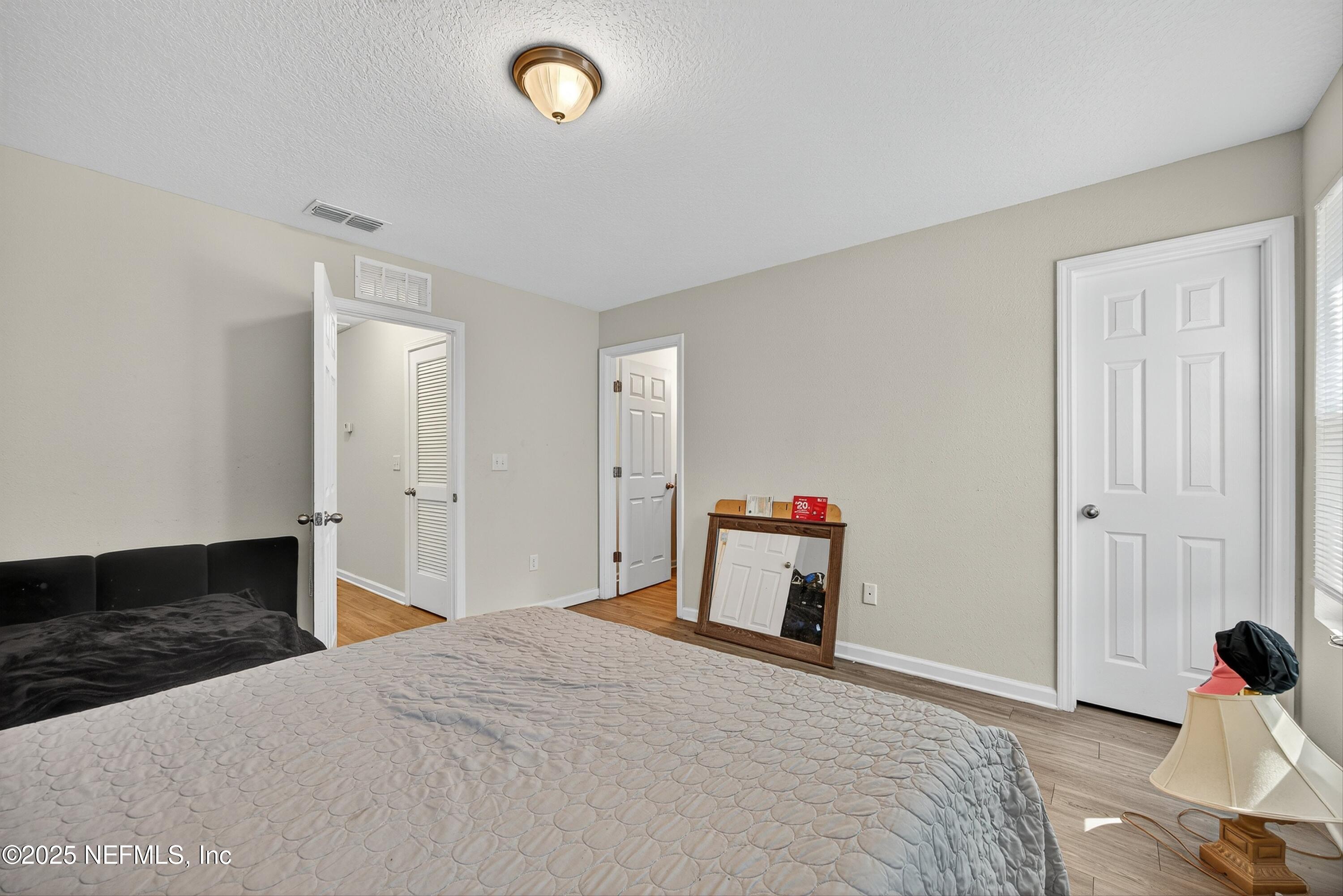 756 Talking Tree Drive Jacksonville, FL 32205 - Photo 15 of 26 a bedroom with a bed and a dresser