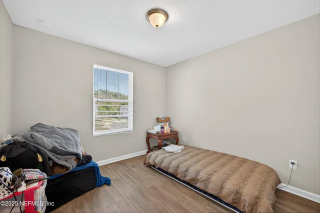 a bedroom with bed and a window