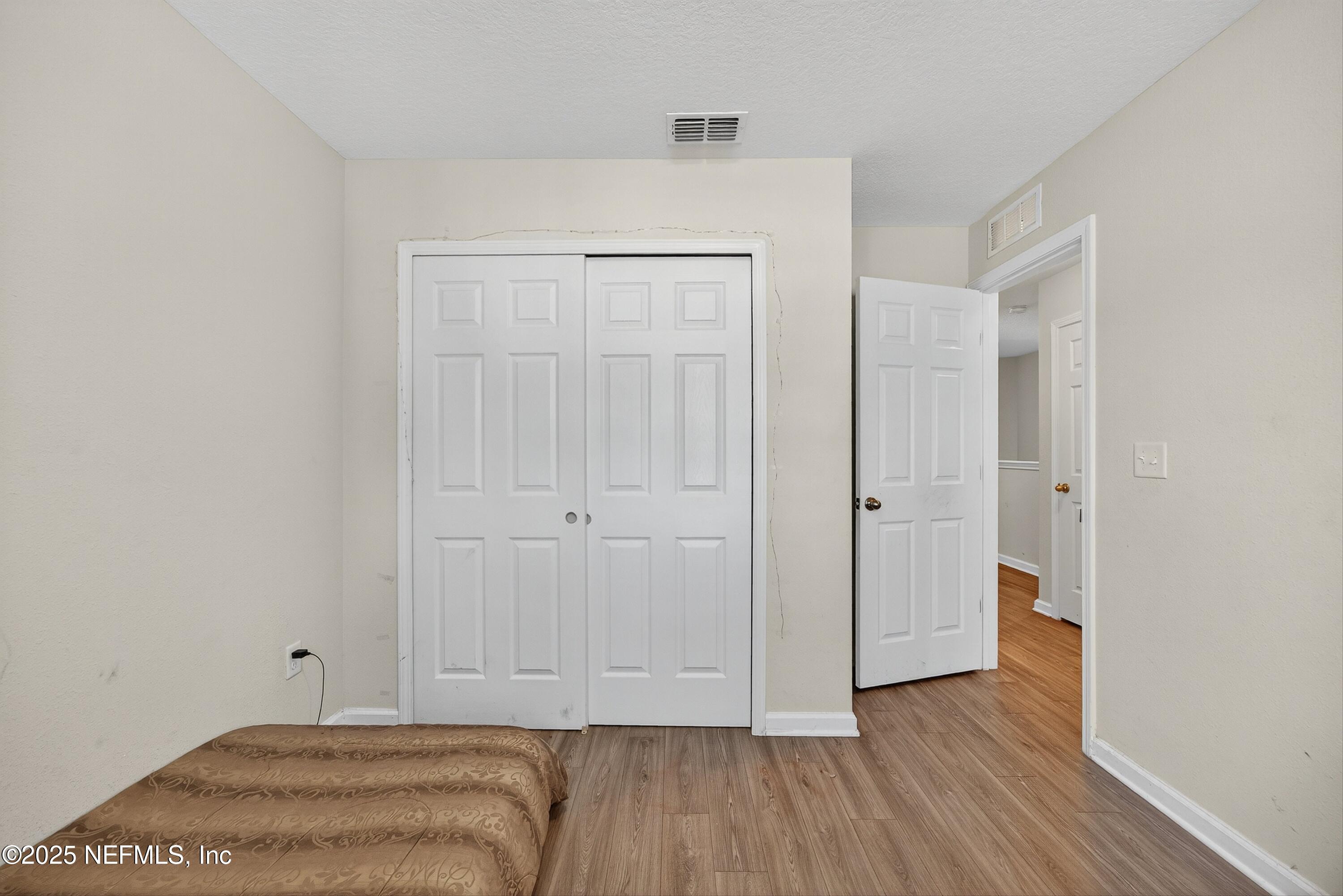 756 Talking Tree Drive Jacksonville, FL 32205 - Photo 18 of 26 a view of bedroom with wooden floor