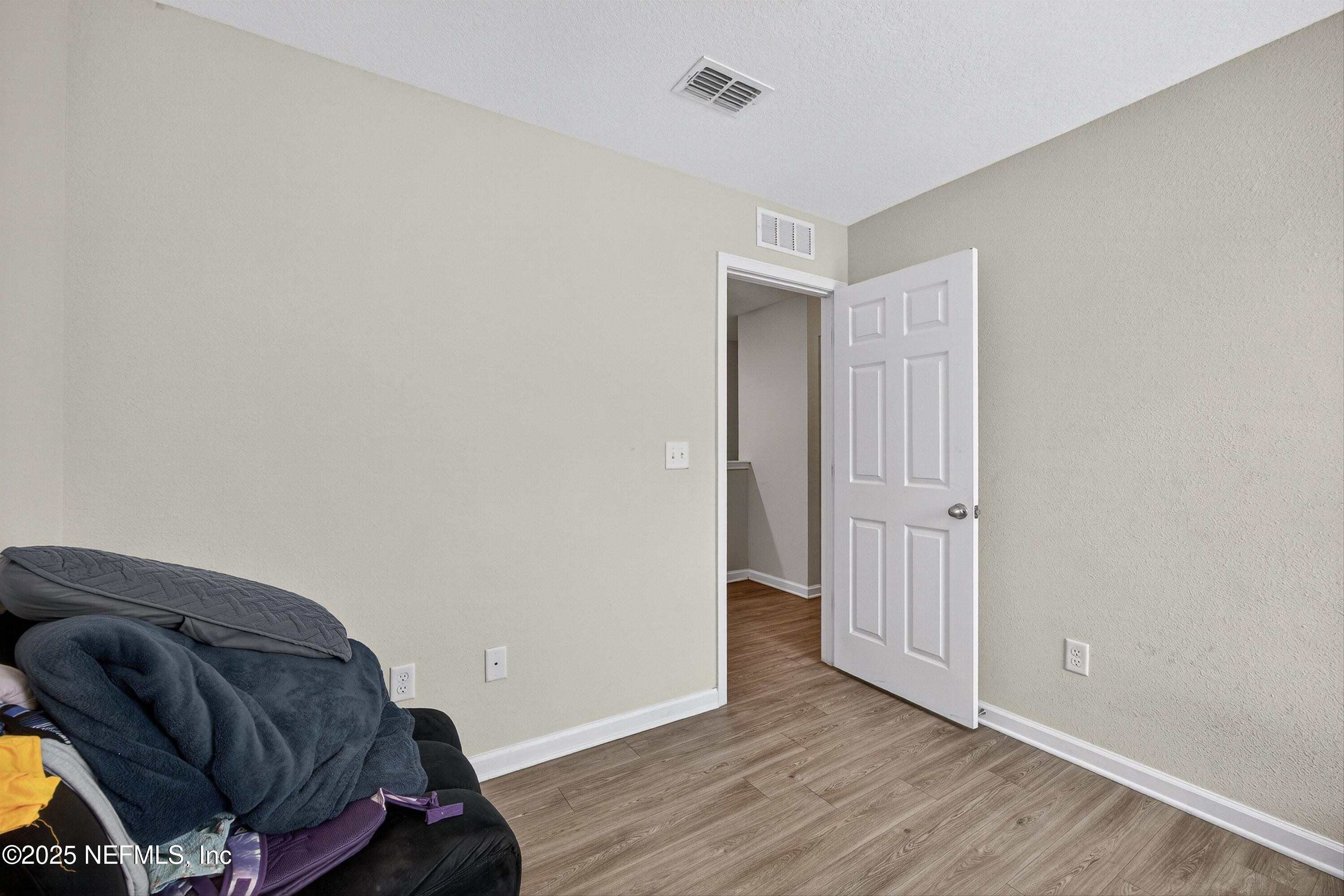 756 Talking Tree Drive Jacksonville, FL 32205 - Photo 20 of 26 a view of bedroom with wooden floor and closet