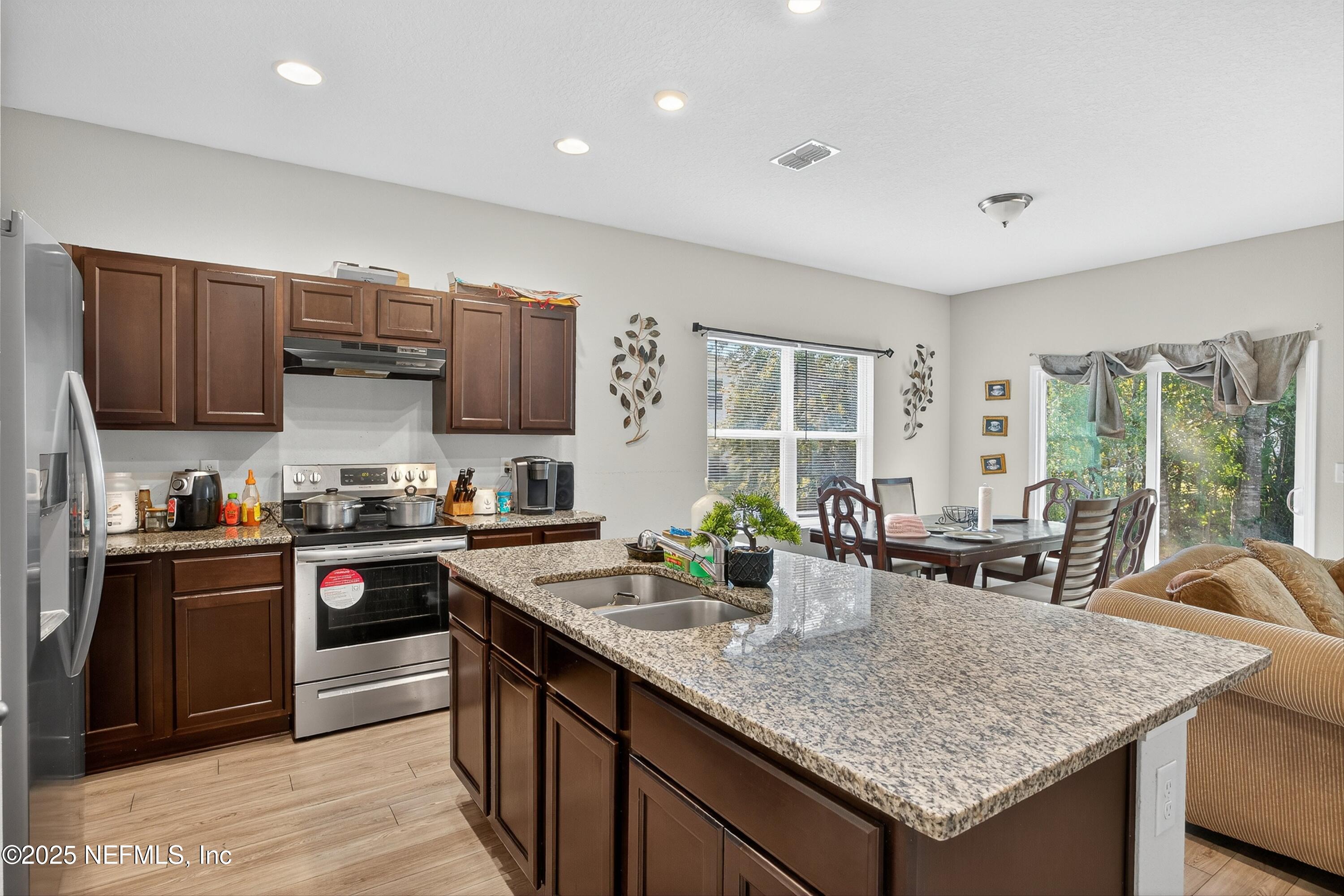 756 Talking Tree Drive Jacksonville, FL 32205 - Photo 2 of 26 a kitchen with granite countertop a sink and cabinets