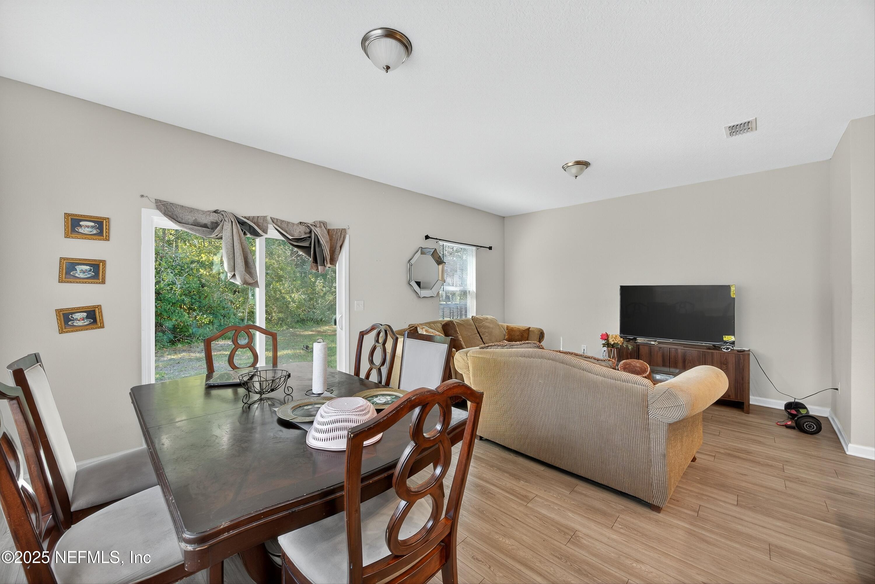 756 Talking Tree Drive Jacksonville, FL 32205 - Photo 3 of 26 a living room with furniture and a flat screen tv