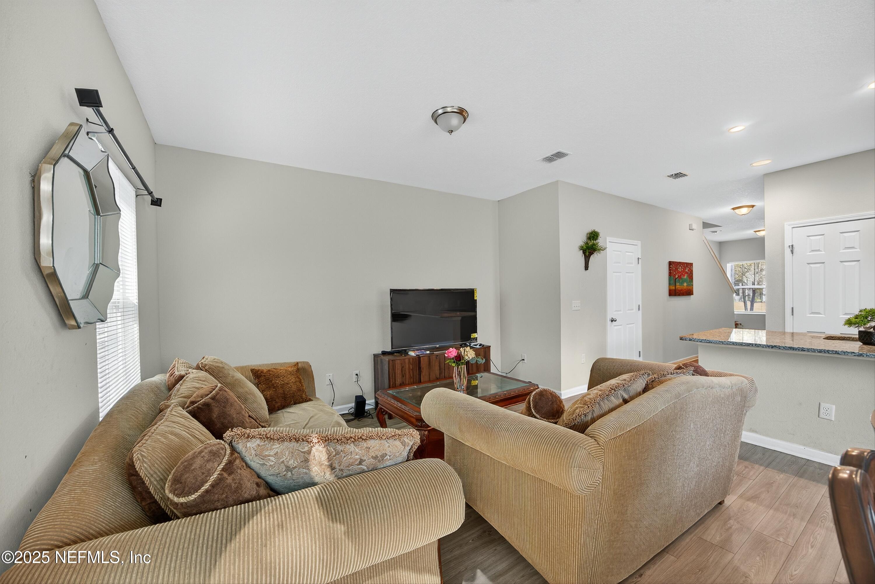 756 Talking Tree Drive Jacksonville, FL 32205 - Photo 10 of 26 a living room with furniture and a flat screen tv