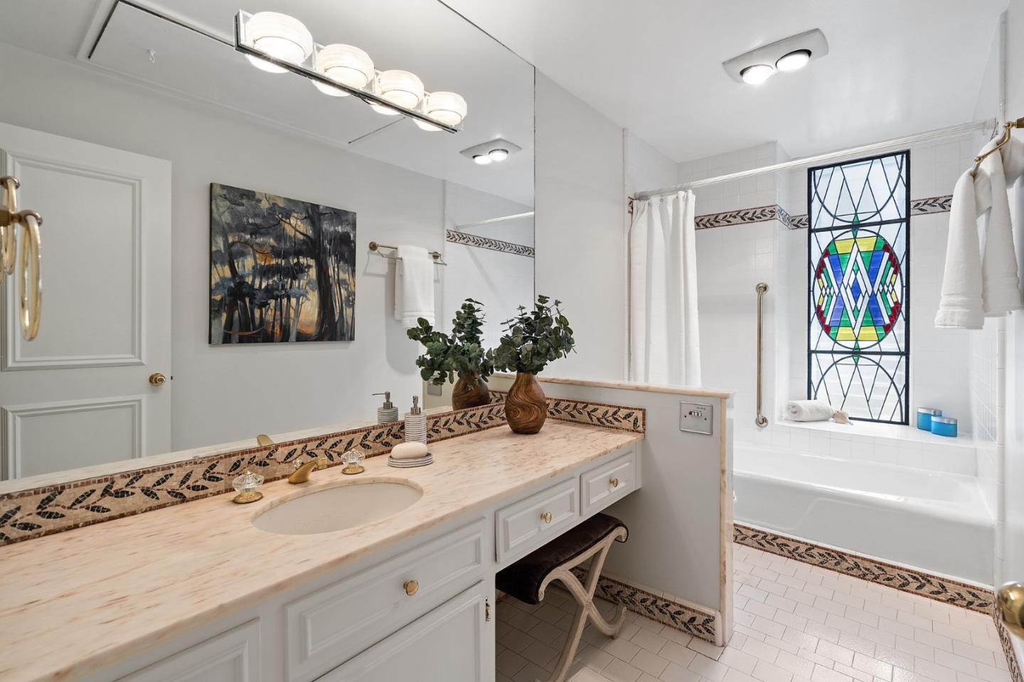 300 Sand Hill Circle, Unit 303 Menlo Park, CA 94025 - Photo 13 of 33 a bathroom with a tub sink and mirror