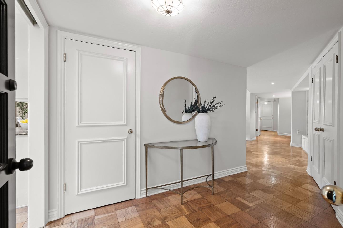 300 Sand Hill Circle, Unit 303 Menlo Park, CA 94025 - Photo 2 of 33 a view of a hallway with a door and a mirror