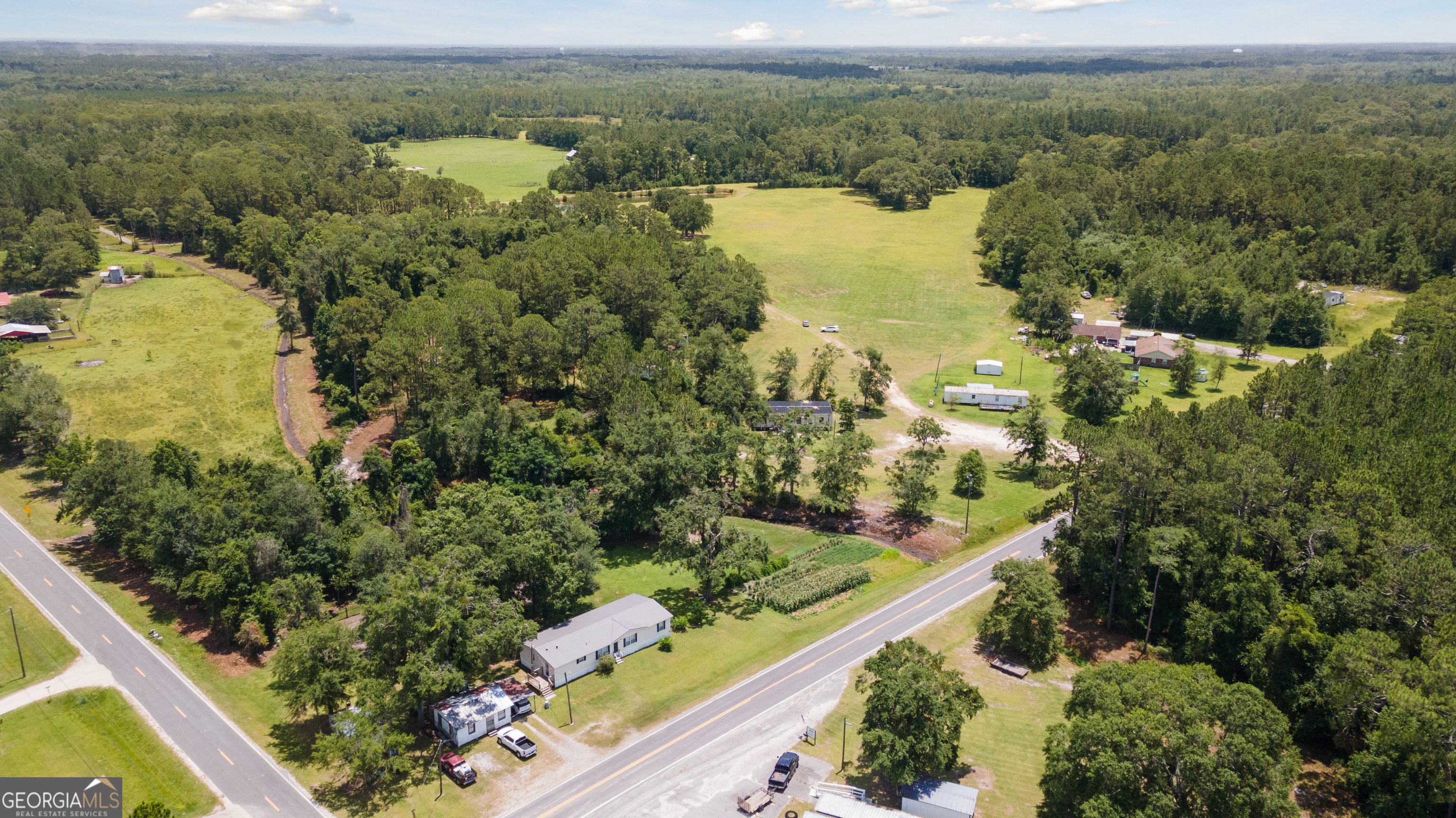 35-acres 35-acres Wells Road Hinesville, GA 31313 - Photo 11 of 14 an aerial view of lake and residential houses with outdoor space