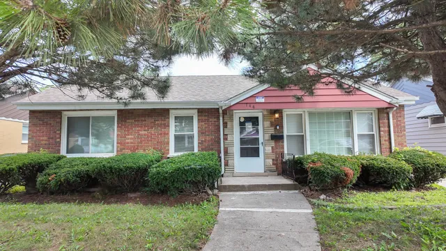 a front view of a house with yard and green space