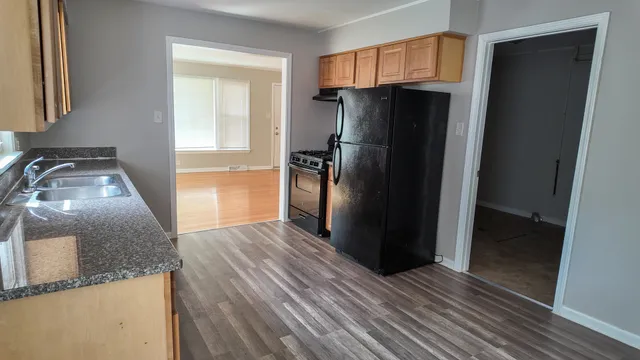 a kitchen with a refrigerator and a sink