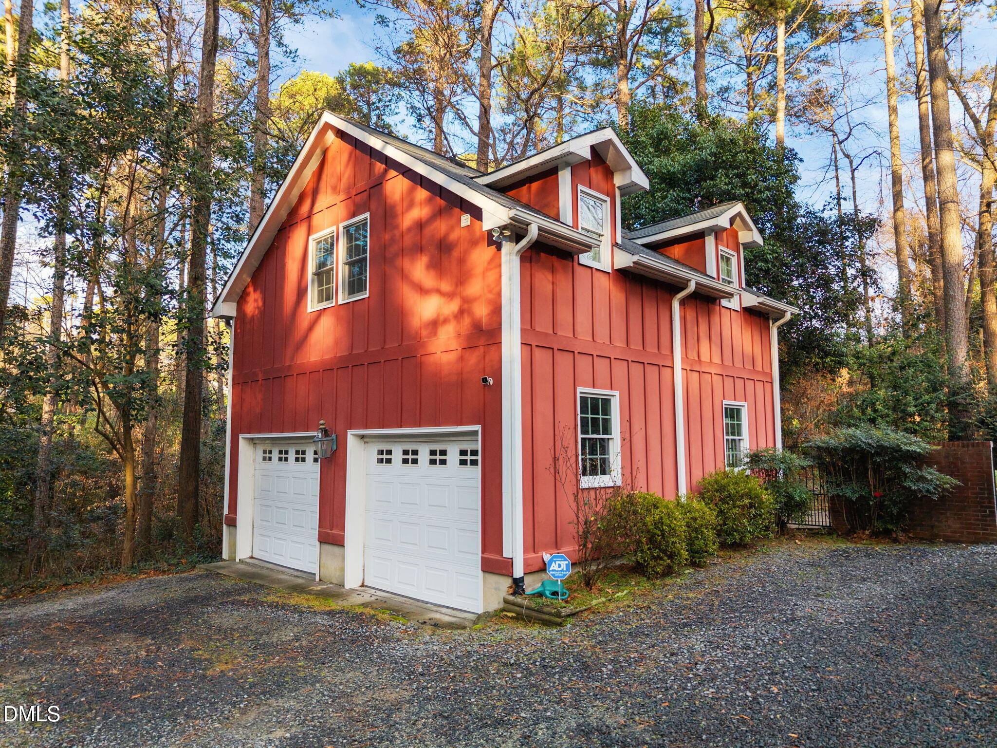 1121 Anderson Street Durham, NC 27705 - Photo 16 of 59 a view of a house with brick walls plants and large tree