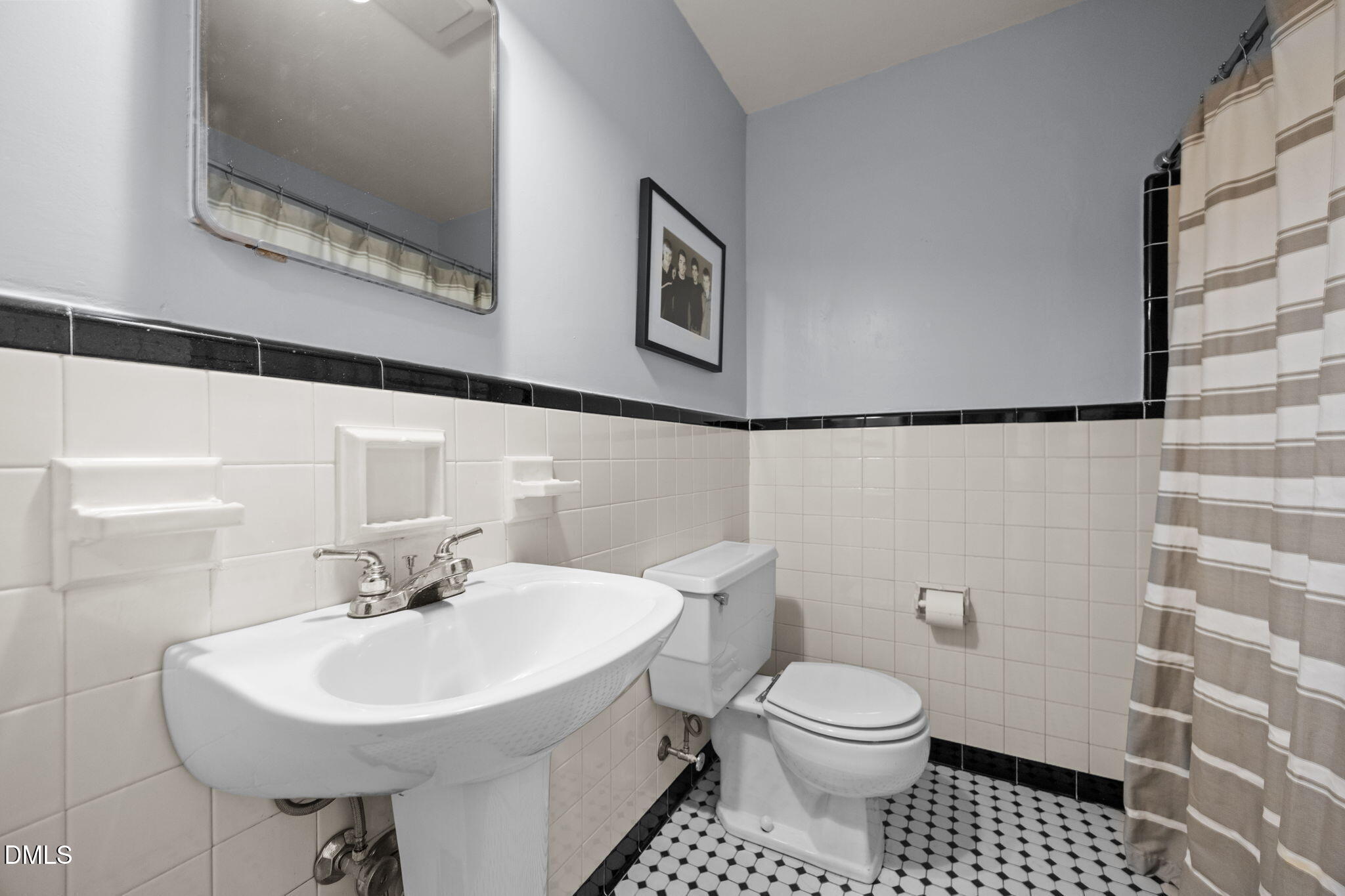 1121 Anderson Street Durham, NC 27705 - Photo 24 of 59 a bathroom with a sink a toilet and a mirror