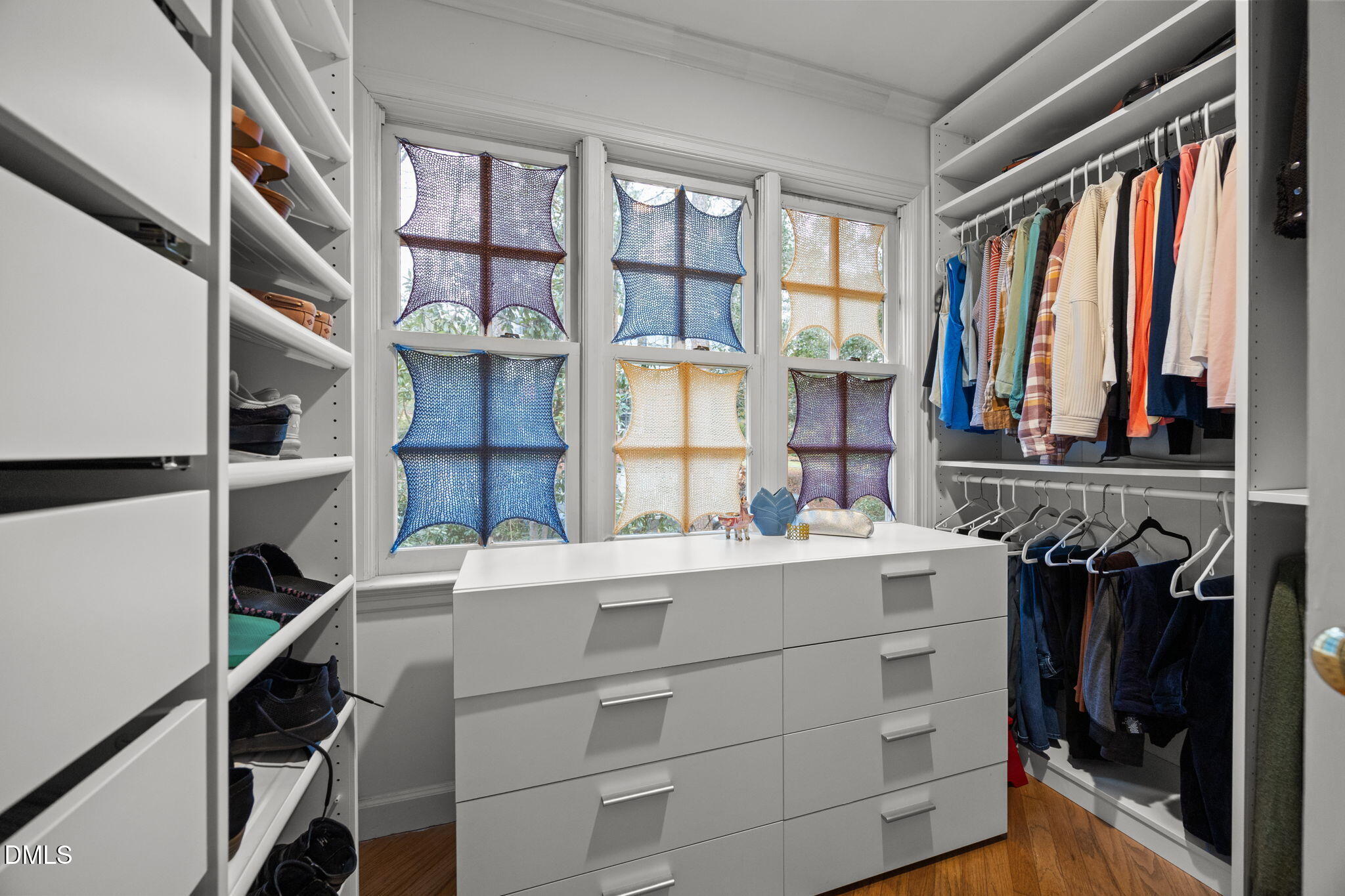 1121 Anderson Street Durham, NC 27705 - Photo 31 of 59 a view of walk in closet with clothes and shoes