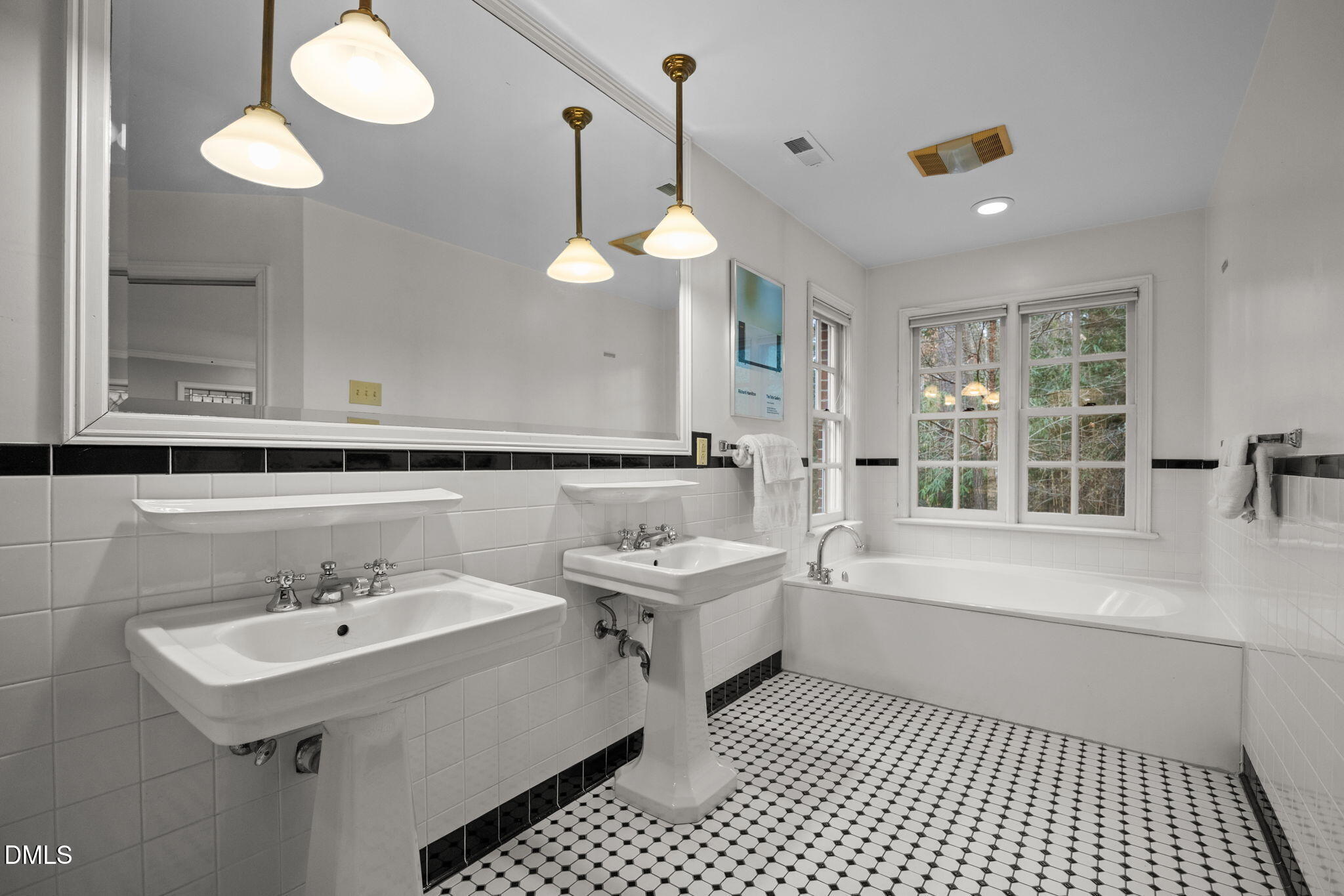 1121 Anderson Street Durham, NC 27705 - Photo 32 of 59 a bathroom with a sink a toilet a mirror and a bathtub