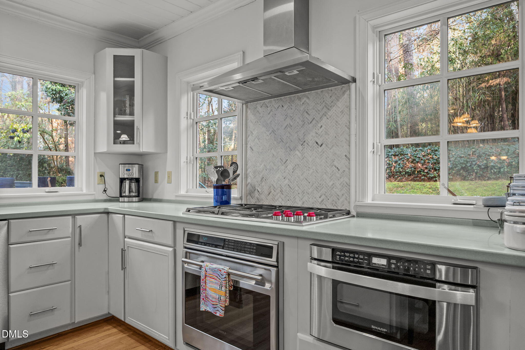 1121 Anderson Street Durham, NC 27705 - Photo 42 of 59 a kitchen with stainless steel appliances a stove a sink and a next to a window