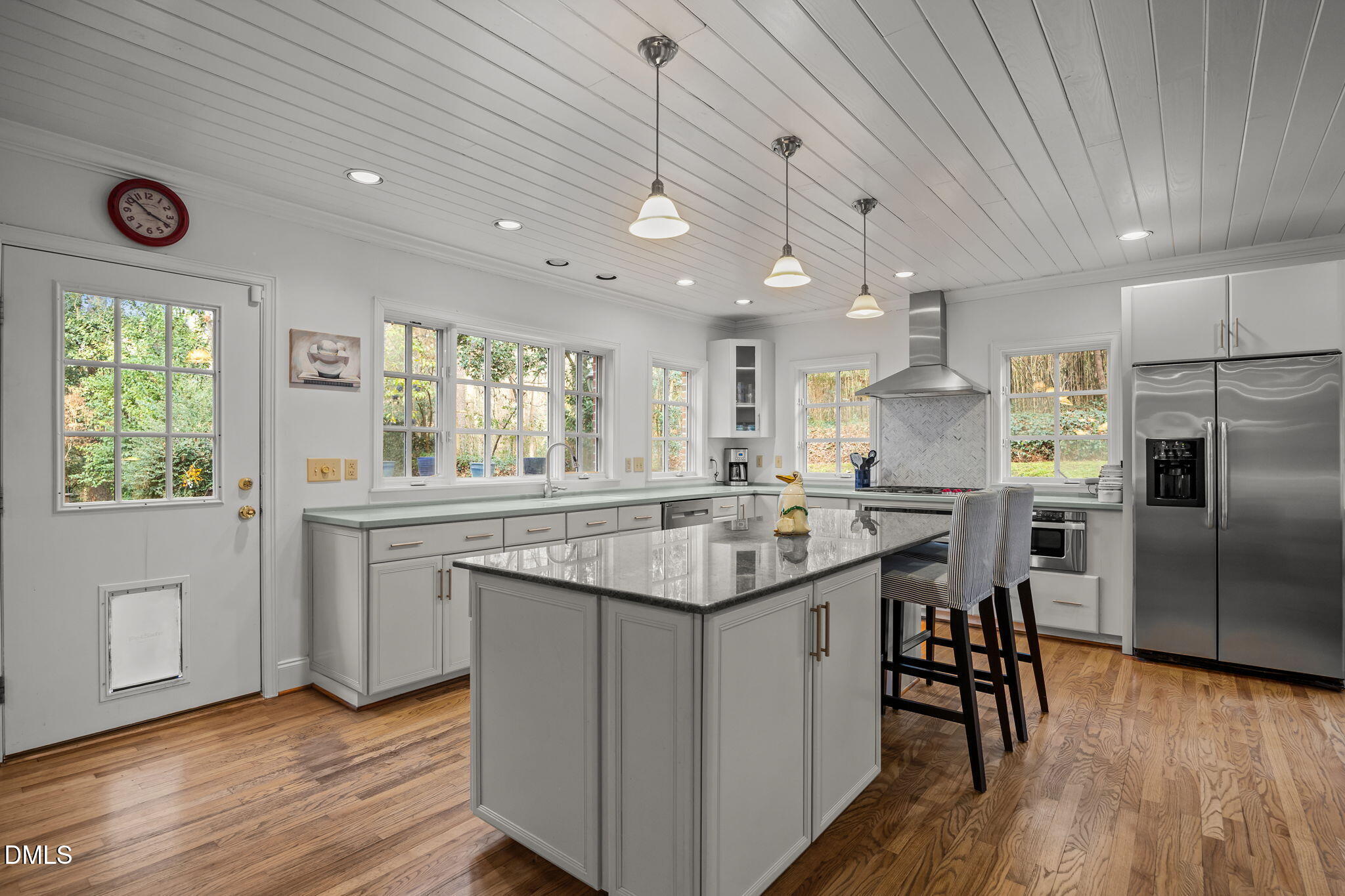 1121 Anderson Street Durham, NC 27705 - Photo 43 of 59 a kitchen with stainless steel appliances granite countertop a sink a stove a refrigerator and island with wooden floor