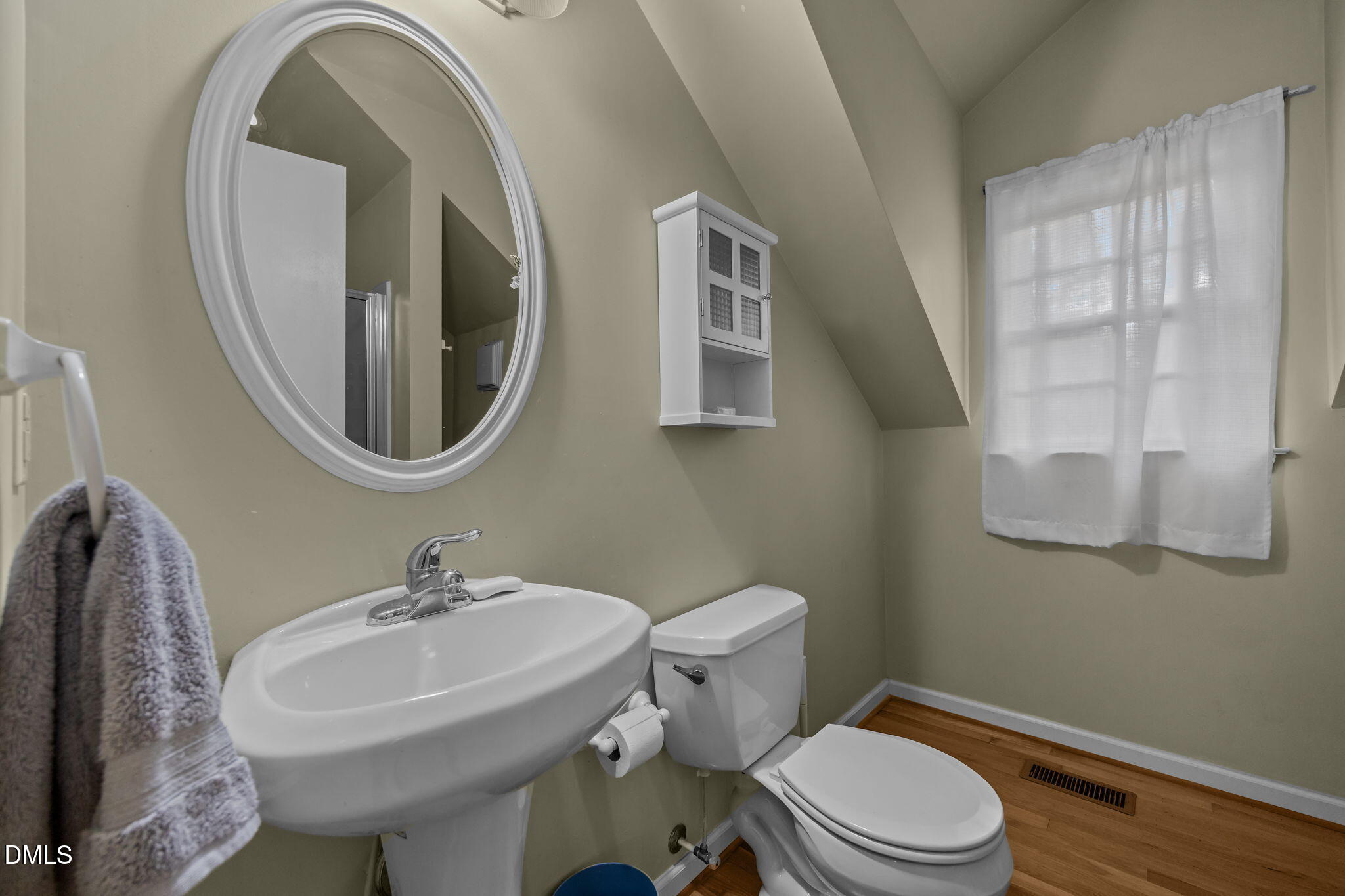 1121 Anderson Street Durham, NC 27705 - Photo 52 of 59 a bathroom with a sink a mirror and a toilet