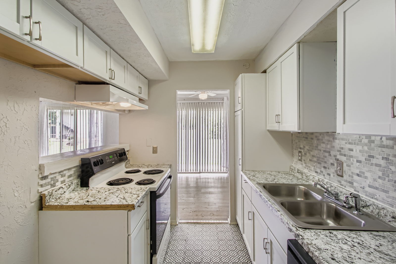 810 Bellevue Road, Unit 120 Nashville, TN 37221 - Photo 12 of 33 a kitchen with granite countertop a sink stove and cabinets