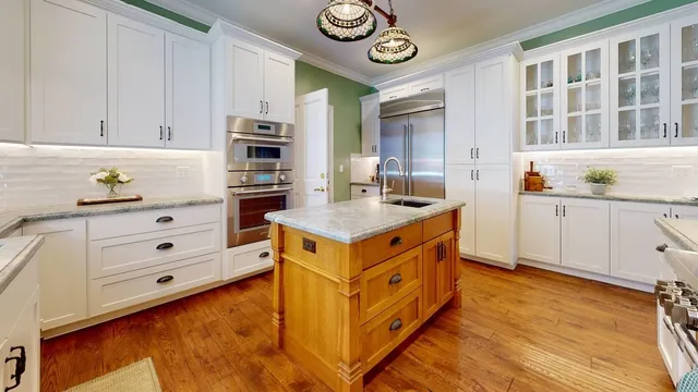 a kitchen with stainless steel appliances granite countertop a stove and a sink