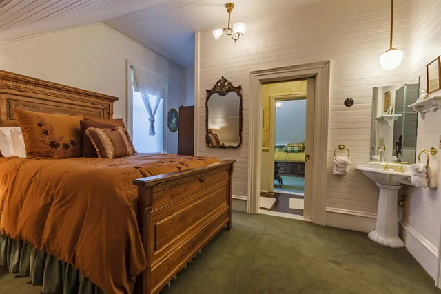 a bedroom with a bed and a mirror