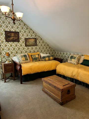 a bedroom with bed and a fireplace