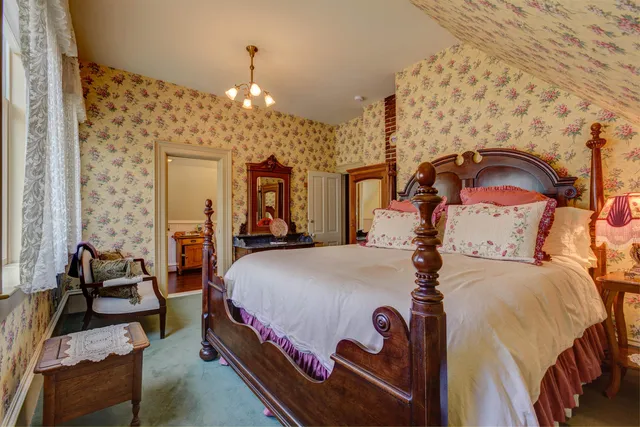 a bedroom with bed and a chandelier