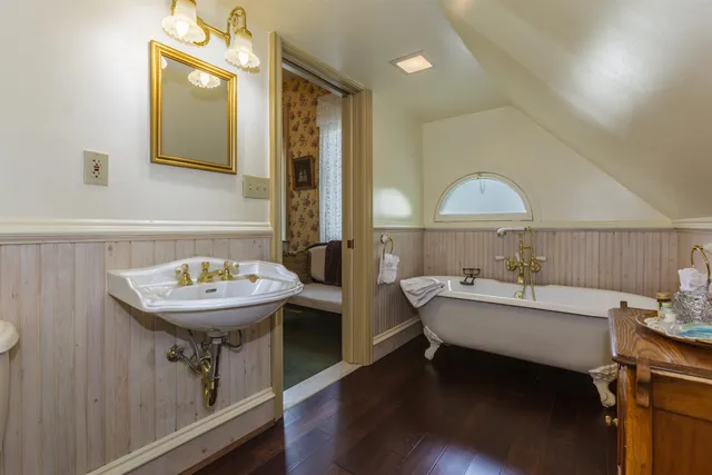 a bathroom with a sink a mirror and a bathtub