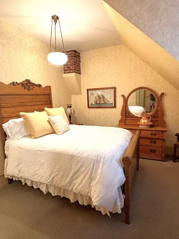 a bedroom with bed and a chandelier