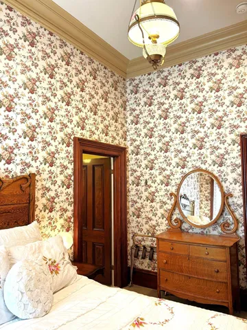 a bedroom with a bed and a mirror