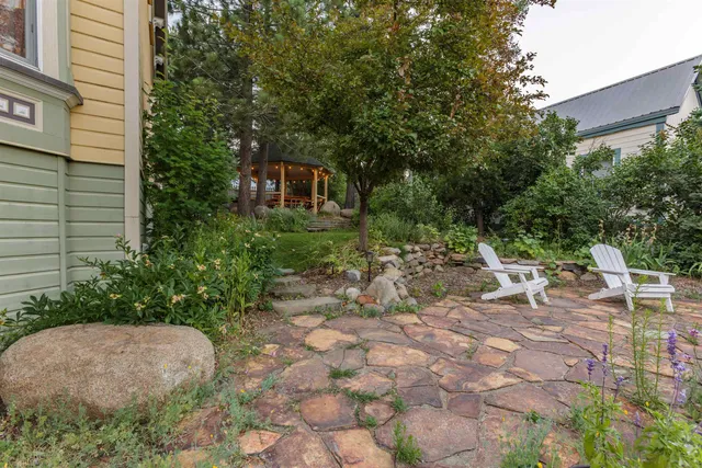 a view of backyard with a table and chairs