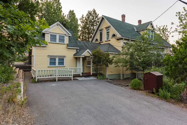 a view of a house with a yard and sitting area