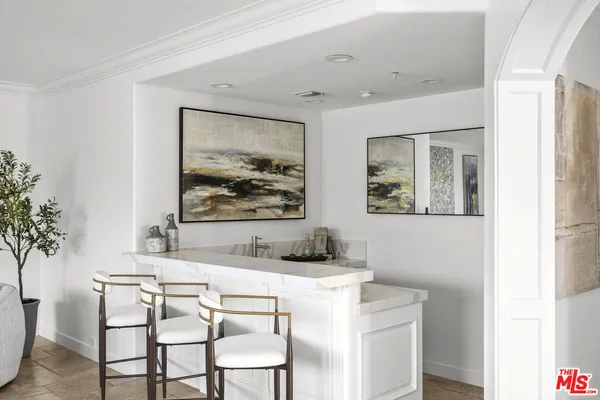 a dining room with a wooden table and chairs