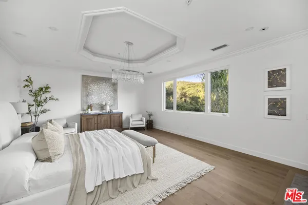 a bed room with a bed and a chandelier
