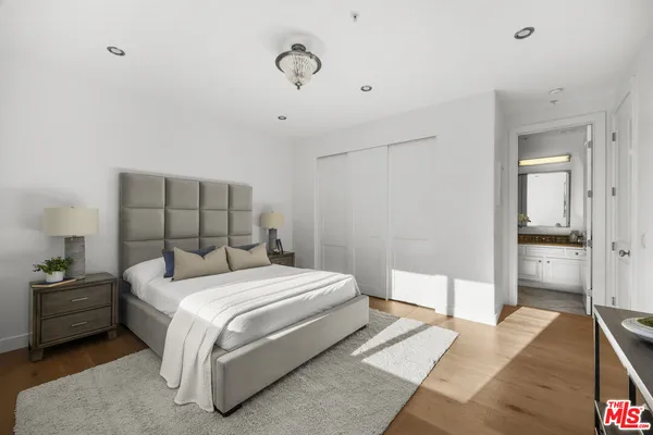a bedroom with a bed and a walk in closet