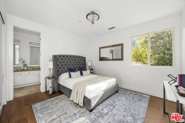 a bedroom with a bed and a table in it