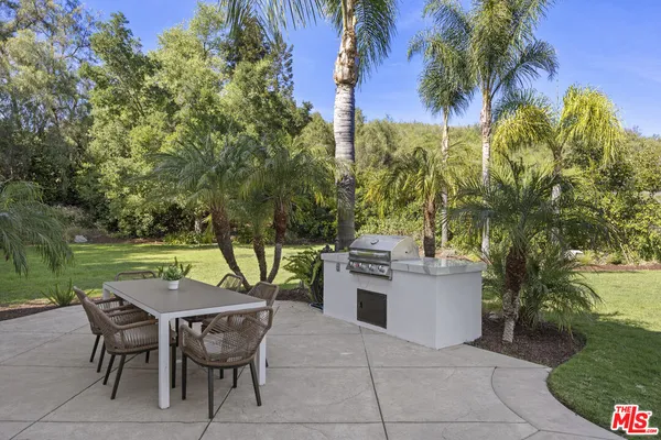 a view of a patio with a table and chairs