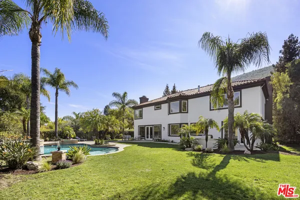 a swimming pool with outdoor seating and yard