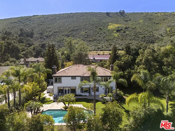 an aerial view of a house with a big yard