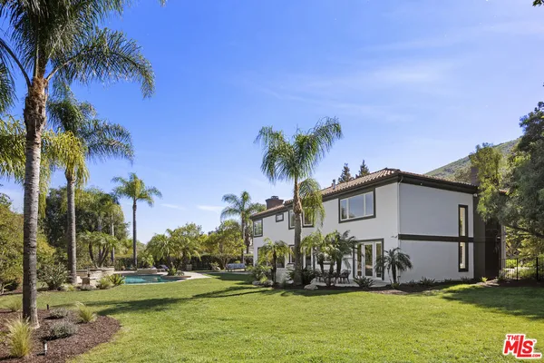 a house with palm tree in front of it