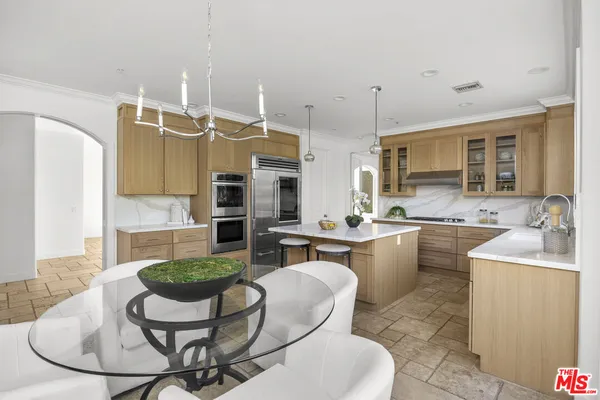 a kitchen with a dining table and chairs